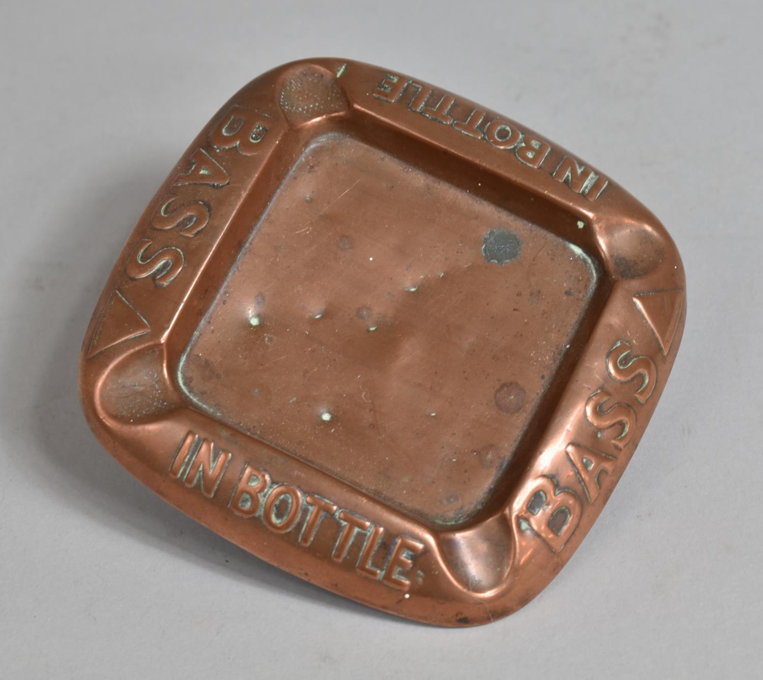 A Vintage Copper Advertising Ashtray, "Bass in Bottle", 12cm Square