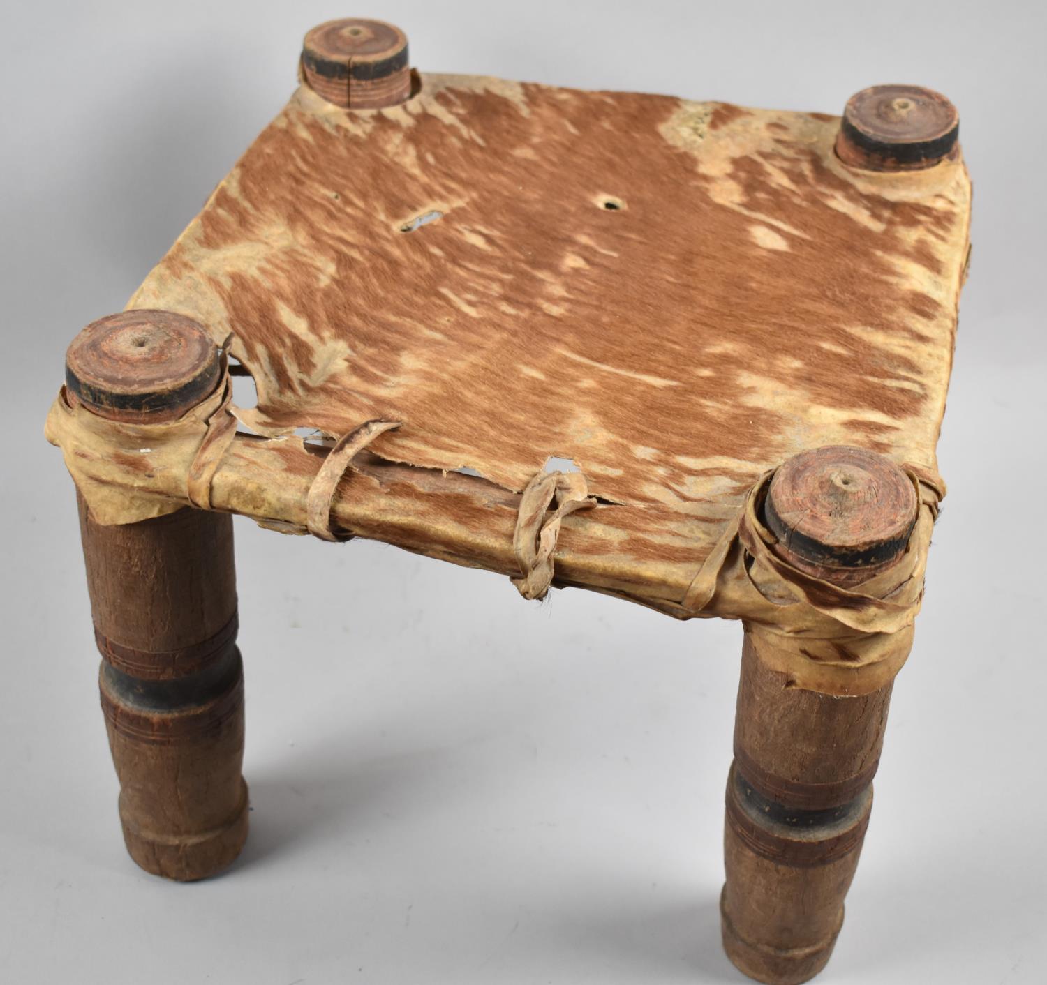 A Vintage African Tribal Stool with Animal Skin Top, Turned Supports, 32cm Square