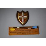 A Shield Shaped Plaque Together with a Rectangular Wall Hanging for Walter Scott and Partners,