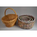 Three Graduated Circular Wicker Baskets and a Wicker Shopping Basket