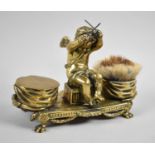 A Late 19th Century French Brass Desktop Inkstand, Having Centre Seated Cherub Holding Drumsticks