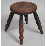 An Early 20th Century Circular Elm Topped Four Legged Stool with Turned Supports, 20cms Diameter and