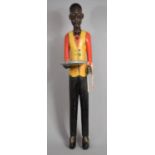 A British Colonial African Carved Wooden Visiting Card Stand Modelled as a Liveried Waiter, with