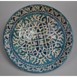 An Iznik Pottery Shallow Bowl decorated in Blue Polychrome Glaze with Geometric Design, 19cms
