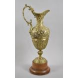 A Heavy Cast Brass Model of a Continental Claret Jug with Mask Head Relief Decoration, Turned