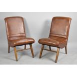 A Pair of Faux Leather Upholstered Low Nursing Chairs