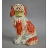 A 19th Century Staffordshire Spaniel with Basket of Flowers in Mouth, 20.5cm high