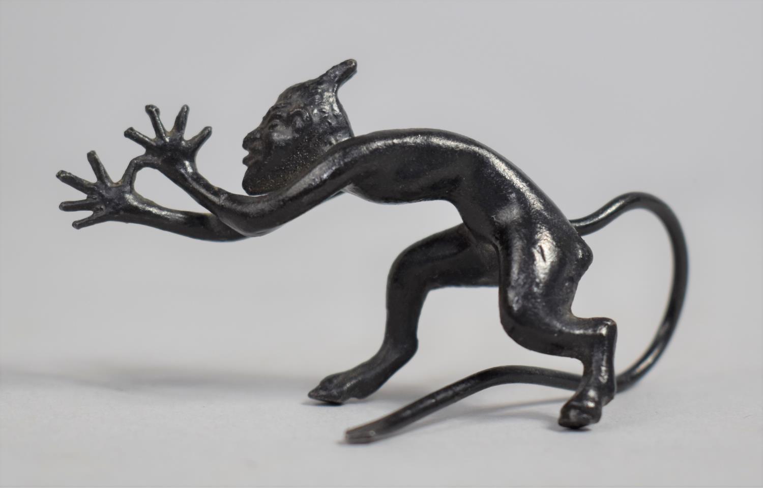 A Small patinated Bronze Study of a Long Tailed Devil, 7cms long