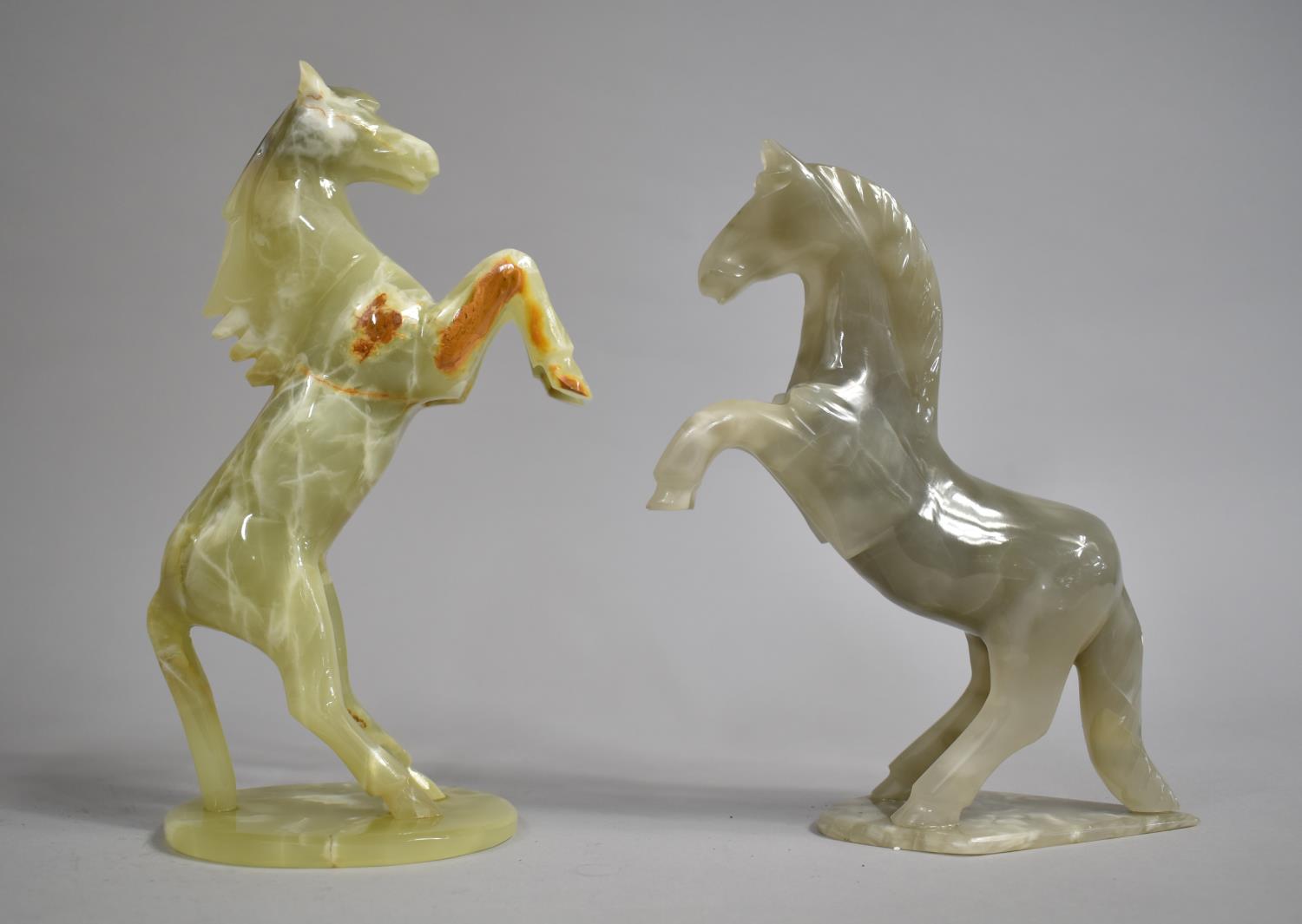 Two Carved and Polish Onyx Studies of rearing Stallions, Tallest 26cms High