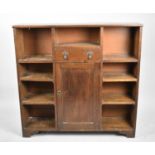 An Edwardian Oak Bookcase with Nine Open Sections, Centre Drawer and Base Shelved Cupboard, 109cms
