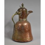 A Large North African Copper Coffee Pot with Brass Handle and Hinged Lid, 62cms High