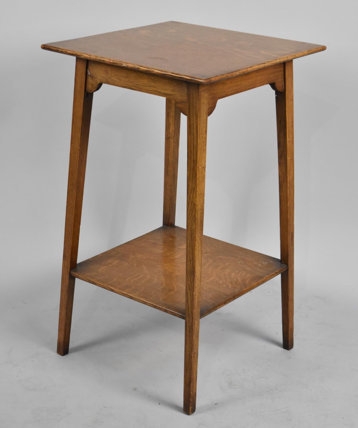 An Edwardian Square Topped Occasional Table with Stretcher Shelf, 76cms High