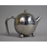 A Silver Plated Teapot with inner Strainer in the Style of Christopher Dresser on Three Ball Feet,