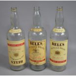 A Collection of Three Vintage 1 Gallon Bells Whisky Bottles