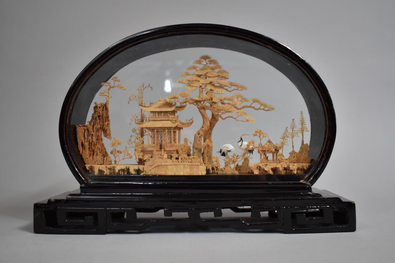 A Finely Carved Corkwood Oriental Diorama Depicting Pagoda and Cranes, Black Lacquered Oval Case