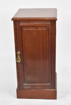 An Edwardian Mahogany Bedside Cabinet with hinged Panelled Door to Shelved Interior, 35cms Wide
