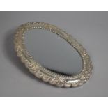 An Oval White Metal Framed Mirror, 31cm x 22cm