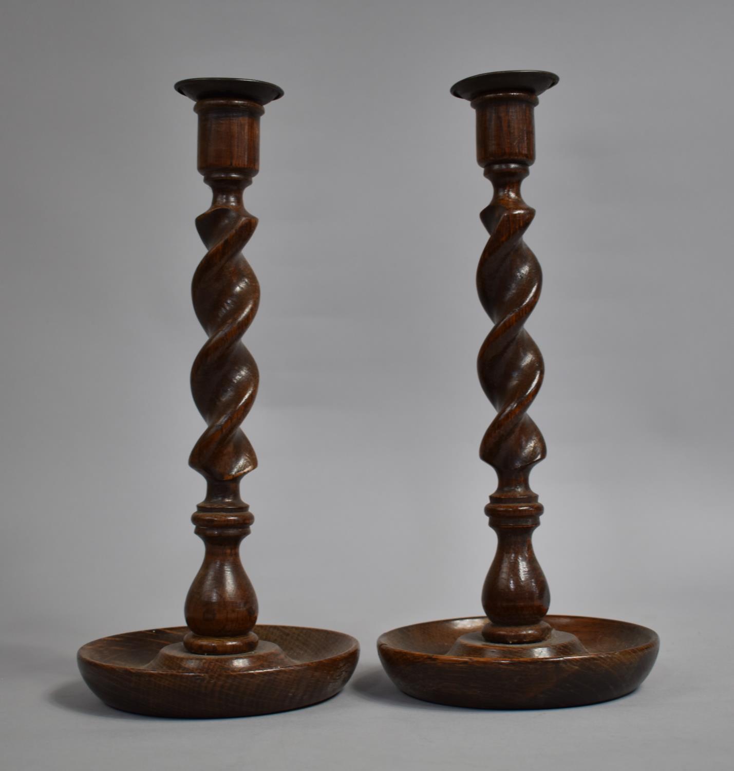 A Pair of Edwardian Oak Candlesticks on Circular Dished Trays, 31cms High