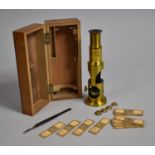 An Edwardian Walnut Cased Brass Field Microscope with Various Prepared Slides, Case 17cms Wide
