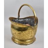 A Brass Helmet Shaped Coal Bucket and Artificial Fruit