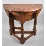 A Small Circular Drop Leaf Oak Occasional Table with Carved Border, 50cms Diameter, 48cms High