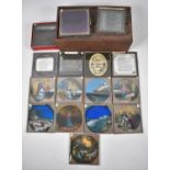 A Wooden Box with Sliding Lid containing Various Coloured and Monochrome Magic Lantern Slides