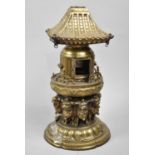 A Far Eastern Brass Temple Censer in the Form of Pagoda with Hinged Doors Supported by Eight
