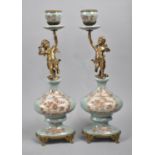 A Pair of French Style Bronze and Porcelain Figural Candlesticks, Supports in the Form of Winged