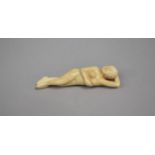 A Carved Bone Oriental Erotic Figure of reclining Nude, 9cms Long