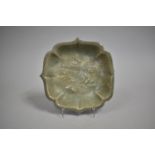 An Oriental Celadon Glazed Square Dish with Relief Decoration, 19cms Square