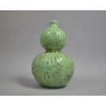 A Green Glazed Chinese Double Gourd Vase decorated in relief with Fruit, 33cms High