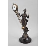 A Reproduction Patinated Bronze Figural Mystery Clock in the Form of a Standing Art Nouveau