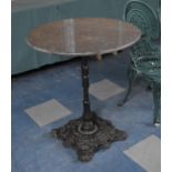 A Cast Iron Based Garden Table with Later Circular Granite Top, Top requires refixing, 70cms