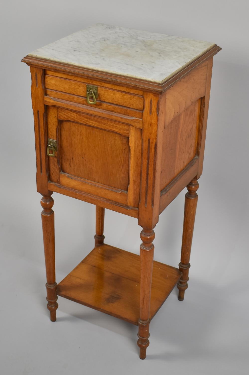 A Late 19th Century Continental Oak Arts and Crafts Style Pot Cupboard with Inset Marble Top over