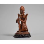 A 19th Century Chinese Carved Boxwood Figure of an Emaciated Wise Man on a Hardwood Stand, 17cms
