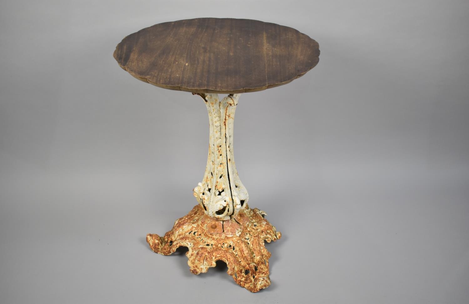 A 19th Century Cast Iron Garden Table in the Style of Coalbrookdale with a Wooden Top and Various