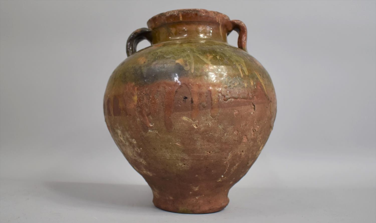 A 19th Century or Earlier Mediterranean Olive Jar with Two Handles and a Half Glazed Body. 24cs High