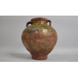 A 19th Century or Earlier Mediterranean Olive Jar with Two Handles and a Half Glazed Body. 24cs High