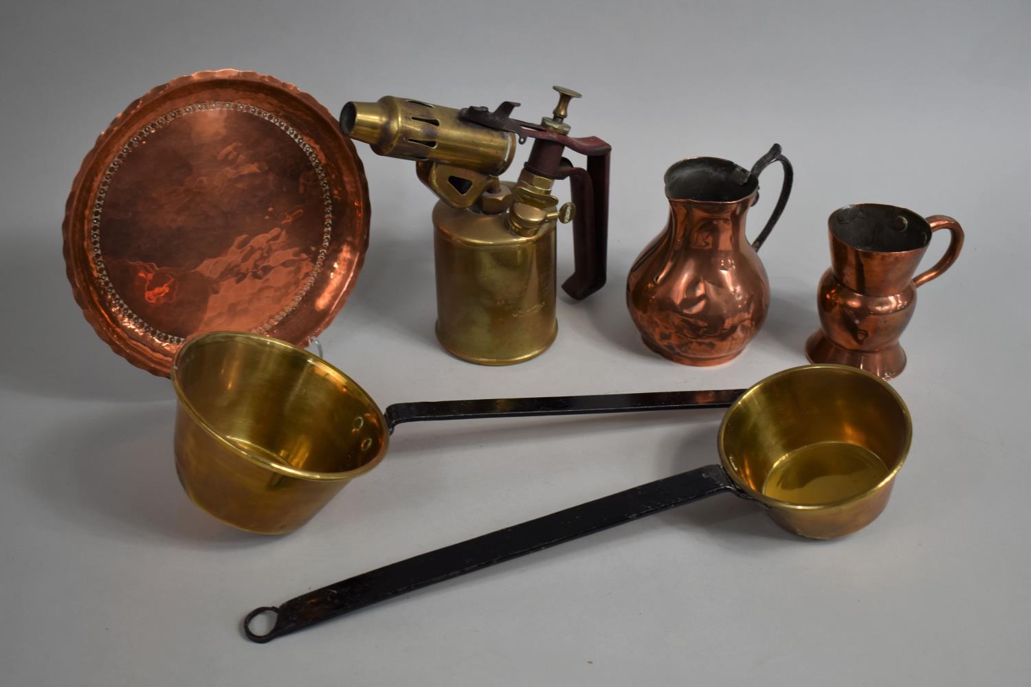 A Collection of Copper and Brass Items to include Measuring Jugs, Blow Torch, Saucepans, Etc