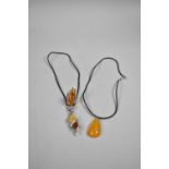 An Amber and Silver Dress Ring, Amber Tear Drop Pendant and Amber Mounted Pendant in the Form of a