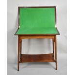 An Edwardian String Inlaid Mahogany Lift and Twist Games Table with Stretcher Shelf, Beize Playing