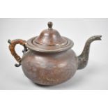 A Hand Beaten North African Copper and Brass Teapot with Caned Handle, 20cm Long