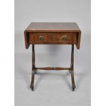 A Reproduction Drop Leaf Coffee Table with Single Drawer on Lyre Supports on Brass Claw Casters,