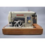 A Vintage Cased Vanguard Electric Sewing Machine, with Foot Pedal