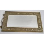 A Rectangular Arts and Crafts Brass Framed Mirror the Border with Repousse Work Fruit, 30x15cm