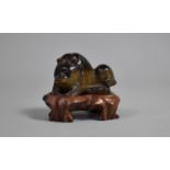 A Carved Tigers Eye Stone Study of a Bear on Carved Wooden Stand, 7cm wide