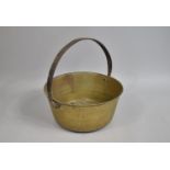 A Vintage Brass Jam Kettle with Iron Loop Handle, 34cm high