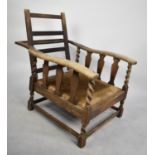 An Edwardian Oak Framed Adjustable Arm Chair with Barley Twist Supports