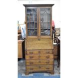 An Edwardian Oak Bureau Bookcase with Astragal Glazed Top, Fall Front to Fitted Interior and Four