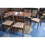 A Modern Mahogany Drop Leaf Crossbanded Dining Table and Set of Six Regency Stripe Chairs